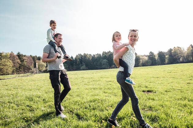 Happy family with two kids on a meadow in spring model released Symbolfoto  WFF00277