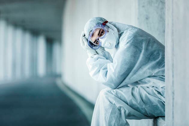Creative Highlights Symbol Portrait of a man wearing protective clothing sitting in a niche of a concrete wall in a tunnel model released Symbolfoto  WVF01513