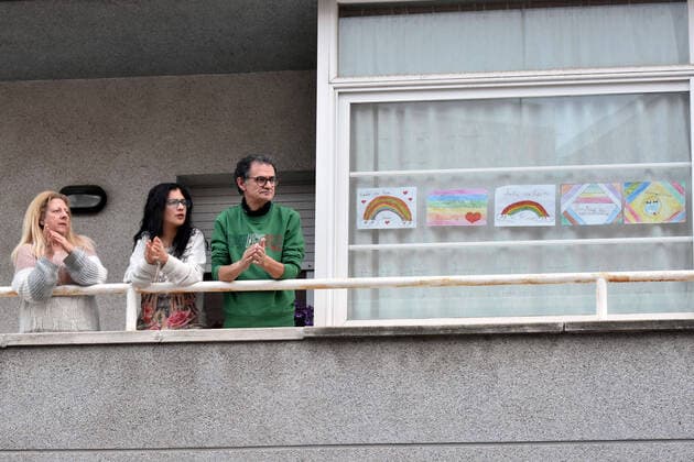 April 2, 2020, El Vendrell, Spain: A family applaud from the terrace of their house to show gratitude to the Covid-19 fighters..In Spain, every night at 08:00 pm and all the cities of the country, citizens who are confined at home during the state of alarm decreed by the Government of Spain since March 16, go out to their terraces and applaud to show gratitude to all the people such as health workers, police, fire fighters, supermarket staff, truckers, and cleaning staff for their great work in fighting the Covid-19 crisis. El Vendrell Spain - ZUMAs197 20200402_zaa_s197_074 Copyright: xRamonxCostax