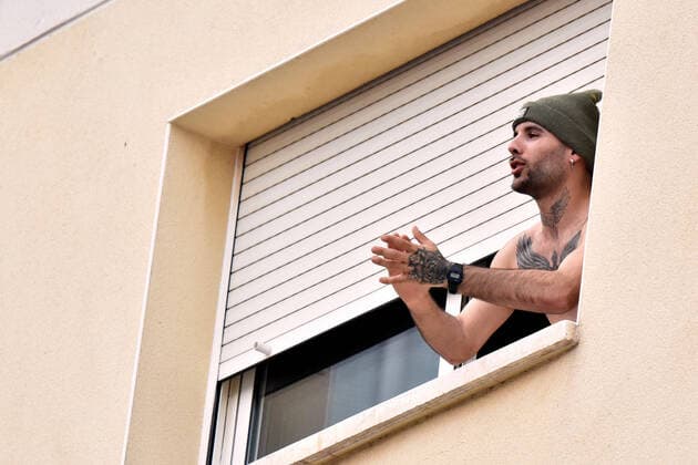 April 2, 2020, El Vendrell, Spain: A man applauds from the terrace of his house to show gratitude to the Covid-19 fighters..In Spain, every night at 08:00 pm and all the cities of the country, citizens who are confined at home during the state of alarm decreed by the Government of Spain since March 16, go out to their terraces and applaud to show gratitude to all the people such as health workers, police, fire fighters, supermarket staff, truckers, and cleaning staff for their great work in fighting the Covid-19 crisis. El Vendrell Spain - ZUMAs197 20200402_zaa_s197_083 Copyright: xRamonxCostax