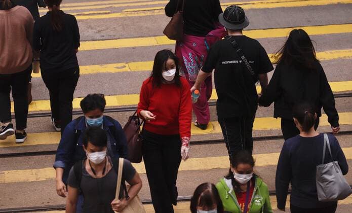 April 3, 2020, Hong Kong, CHINA: Woman with facemask and vinyl glove ( woman in red dress ) crossing the zebra in Central. According to WHO, global infections of coronavirus introduced by China Pneumonia is almost reaching 1 million in a few days, continue to spread with alarming speed showing no sign of dissipation.April-3,2020 Hong Kong.ZUMA Hong Kong CHINA - ZUMAl137 20200403_zap_l137_007 Copyright: xLiauxChung-renx