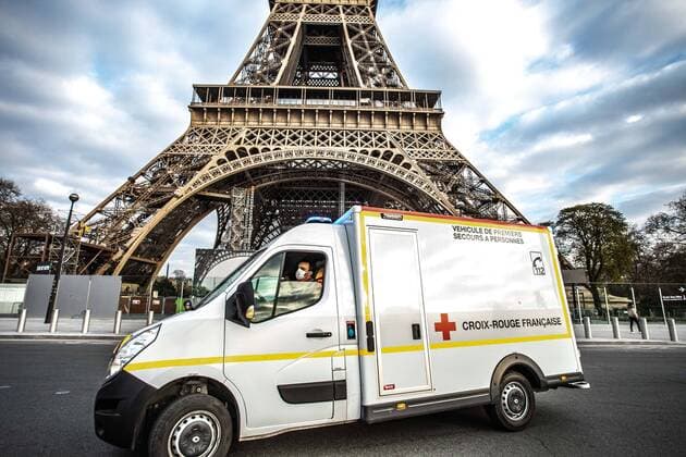 An ambulance of the Croix Rouge (Red Cross) drives and turns quickly in front of the Eiffel Tower during the restrictions of movement of the citizens and the measures of confinement of the coronaviruses in Paris, France, on April 02, 2020.  Copyright: xChristophexMorinx