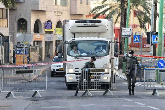 (200403) -- BNEI BRAK, April 3, 2020 (Xinhua) -- Israeli Border Police block the main road in the central Israeli city of Bnei Brak on April 3, 2020. The Israeli government has declared the Jewish ultra-Orthodox city of Bnei Brak a restricted area because of the high infection rate of COVID-19, Israel s Prime Minister Office said Thursday. (JINI Handout via Xinhua) MIDEAST-BNEI BRAK-COVID-19 