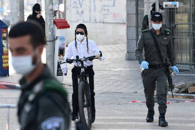 (200403) -- BNEI BRAK, April 3, 2020 (Xinhua) -- Israeli Border Police block the main road in the central Israeli city of Bnei Brak on April 3, 2020. The Israeli government has declared the Jewish ultra-Orthodox city of Bnei Brak a restricted area because of the high infection rate of COVID-19, Israel s Prime Minister Office said Thursday. (JINI Handout via Xinhua) MIDEAST-BNEI BRAK-COVID-19 