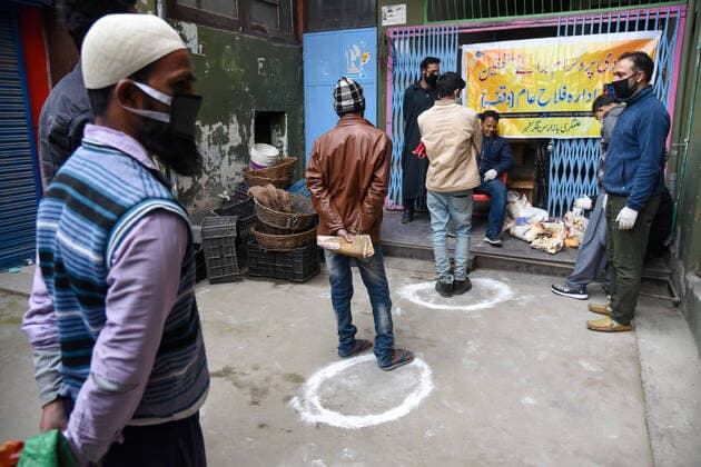 April 3, 2020, Srinagar, Jammu & Kashmir, India: Non local workers maintain the social distance as a preventive measure while in queue receiving aid from a local non government organisation, during the lockdown..Indian Prime Minister, Narendra Mondi announced 21 day lockdown on 22 March across the country restricting the movement of people from stepping out of their home to curb the spread of the corona virus. More than 2500 tested positive for corona virus in India with 71 deaths. Srinagar India - ZUMAs197 20200403_zaa_s197_070 Copyright: xIdreesxAbbasx