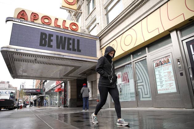 Pedestrians walk by the Be Well message on the Apollo Theater marquee in the Harlem section of New York City on Friday, April 3, 2020. The Coronavirus deaths have doubled in the past 3 days to almost 3,000 deaths.  NYP20200403107 JOHNxANGELILLO