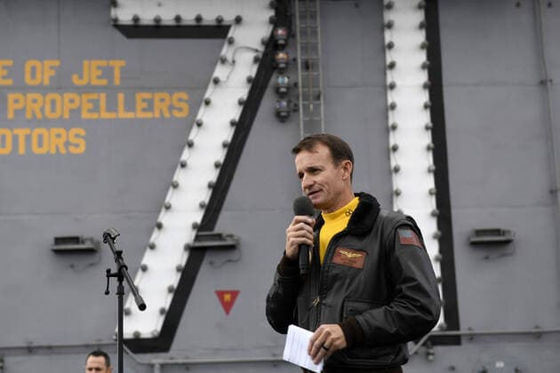 Capt. Brett Crozier, commanding officer of the aircraft carrier USS Theodore Roosevelt (CVN 71), addresses the crew during an all-hands call on the ship s flight deck on November 14, 2019. On April 2, 2020, Capt. Crozier was relieved of his command after sending a letter earlier in the week requesting additional resources to deal with a coronavirus outbreak on the aircraft carrier.  WAX2020040301 NICHOLASxHUYNH