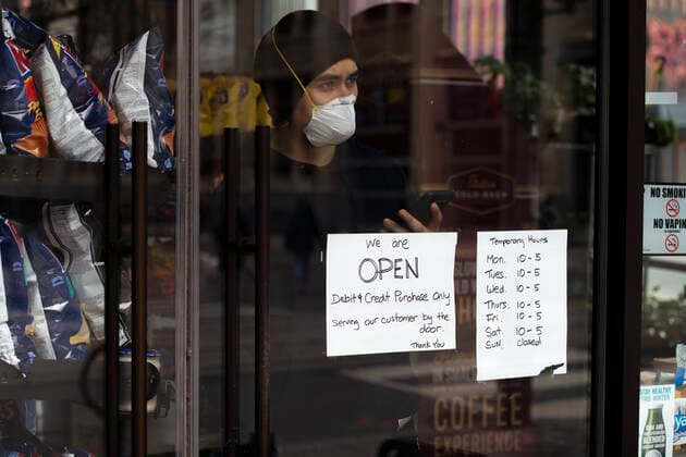 April 3, 2020: A Queen St. store clerk stands at the door to attend to customers in Toronto. With the spread of COVID-19 growing in Canada, many stores have restricted hours and protocol if not closed entirely. - ZUMAc232 20200403_zip_c232_012 Copyright: xGilesxCampbellx