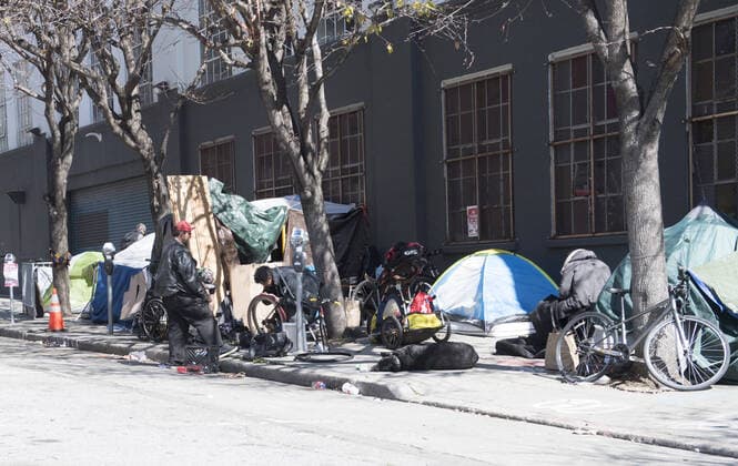 Tents and homeless occupy the sidewalk in San Francisco on Friday, April 3, 2020. San Francisco is trying to spread out their homeless to avoid the coronavirus.  SXP2020040309 TERRYxSCHMITT