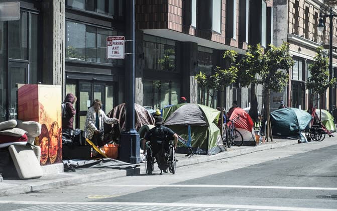Tents and homeless occupy the sidewalk on Eddy Street in the Tenderloin district of San Francisco on Friday, April 3, 2020. San Francisco is trying to spread out their homeless to avoid the coronavirus.  SXP2020040313 TERRYxSCHMITT