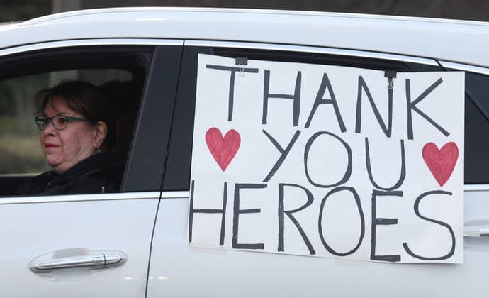 April 3, 2020, Racine, Wisconsin, USA: Hundreds of cars packed the campus of Ascension All Saints Hospital in Racine, Wisconsin Friday April 3, 2020 to show their support to the staff. The event, suggested by a NICU nurse, for cars to parade through the grounds flashing their headlights, was billed as Flashin First Friday because the traditional downtown First Fridays during which stores stay open late was canceled. ADRIENNE CRAMER drove an hour from her Illinois home to support her daughter who works at the hospital. So many cars came that the parade stalled that most cars just parked facing the hospital buildings and honked their horns for an hour. Racine County reported its first COVID-19 death Friday. Racine USA - ZUMAh154 20200403_znp_h154_011 Copyright: xMarkxHertzbergx