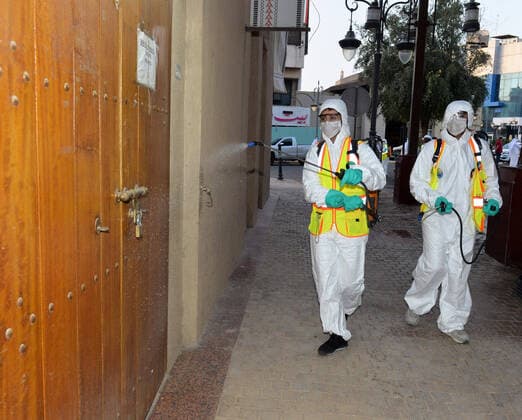 (200403) -- KUWAIT CITY, April 3, 2020 (Xinhua) -- Workers disinfect a street in Kuwait City, Kuwait, on April 3, 2020. Kuwait reported on Friday 75 new COVID-19 cases, bringing the total number in the country to 417, the Health Ministry said in a statement. (Photo by Asad Xinhua) KUWAIT-KUWAIT CITY-COVID-19-DISINFECTION 