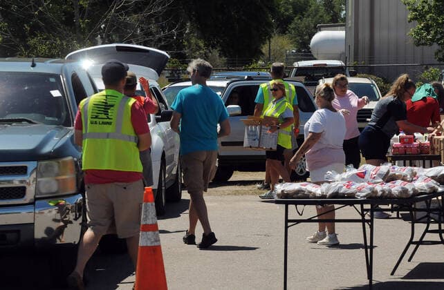 April 3, 2020, Groveland, Florida, United States: Volunteers prepare packages of food items from the Second Harvest Food Bank of Central Florida for distribution to the needy at a drive through event that served over 350 families at the Faith Neighborhood Center near Orlando. .The coronavirus pandemic has put thousands of local service employees and theme park workers out of work, placing a strain on area food banks. Groveland United States - ZUMAs197 20200403_zaa_s197_343 Copyright: xPaulxHennessyx