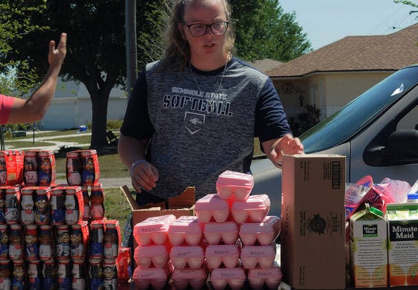 April 3, 2020, Groveland, Florida, United States: A volunteer prepares packages of eggs, milk, and orange juice from the Second Harvest Food Bank of Central Florida for distribution to the needy at a drive through event that served over 350 families at the Faith Neighborhood Center near Orlando. The coronavirus pandemic has put thousands of local service employees and theme park workers out of work, placing a strain on area food banks. Groveland United States - ZUMAs197 20200403_zaa_s197_348 Copyright: xPaulxHennessyx