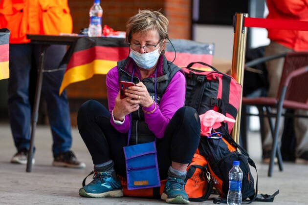 April 4, 2020, Kathmandu, Nepal: A tourist on a phone from Germany wears a protective mask has awaits for a flight back to home at Tribhuvan International Airport..European countries including Germany and France are taking back more than 600 citizens stranded in Nepal toady. Kathmandu Nepal - ZUMAs197 20200404_zaa_s197_020 Copyright: xPrabinxRanabhatx