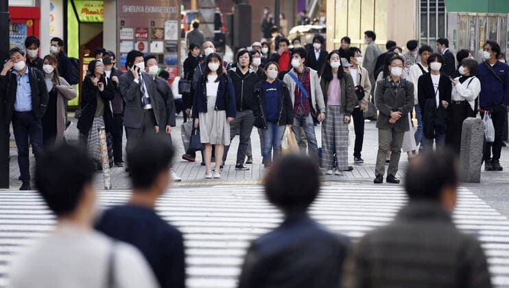 New coronavirus People wear masks near JR Shibuya Station in Tokyo on April 4, 2020, amid the spread of the new coronavirus. 
