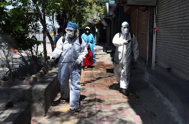 NEW DELHI, INDIA APRIL 4: Men spray disinfectants during a sanitization effort by the Tibetan community at Majnu ka Tilla, on day eleven of the nationwide lockdown to check the spread of coronavirus, on April 4, 2020 in New Delhi, India. (Photo by Mohd Zakir Hindustan Times ) Sanitation Drive During Three Week Lockdown To Stop Spread Of Coronavirus COVID-19