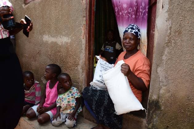 (200404) -- KAMPALA, April 4, 2020 (Xinhua) -- A woman holds relief food she received during the door-to-door food distribution in Kampala, capital of Uganda, April 4, 2020. Uganda on Saturday started relief food distribution to about 1.5 million urban poor who are affected by the lockdown as a measure to contain the COVID-19 outbreak in the country. (Photo by Nicholas Kajoba Xinhua) UGANDA-KAMPALA-RELIEF FOOD DISTRIBUTION-COVID-19 