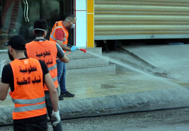(200404) -- BAGHDAD, April 4, 2020 (Xinhua) -- Volunteers sterilize a street in Baghdad, Iraq, on April 4, 2020. Iraqi Health Ministry on Saturday confirmed two more deaths from COVID-19 and 58 new cases, as the total number of infections climbed to 878. (Xinhua Khalil Dawood) IRAQ-BAGHDAD-COVID-19-NEW CASES 