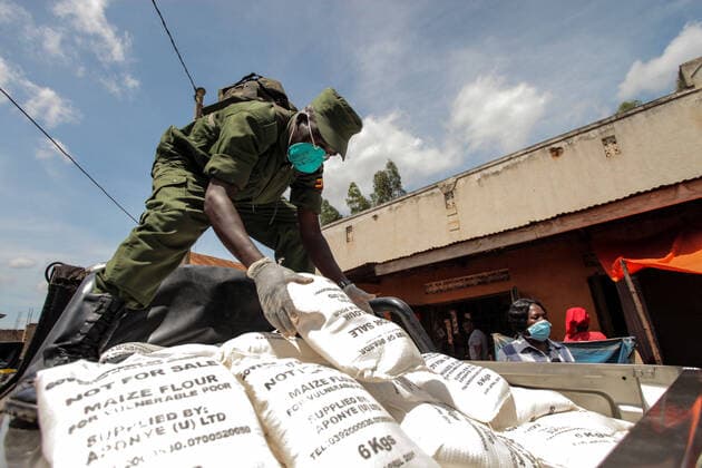 (200404) -- KAMPALA, April 4, 2020 (Xinhua) -- A military officer arranges bags of maize flour during the relief food distribution in Kampala, capital of Uganda, April 4, 2020. Uganda on Saturday started relief food distribution to about 1.5 million urban poor who are affected by the lockdown as a measure to contain the COVID-19 outbreak in the country. (Photo by Hajarah Nalwadda Xinhua) UGANDA-KAMPALA-RELIEF FOOD DISTRIBUTION-COVID-19 