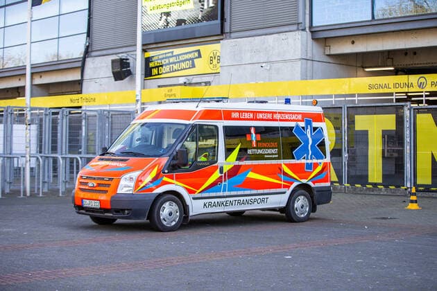 (200405) -- DORTMUND, April 5, 2020 (Xinhua) -- An ambulance is seen outside the COVID-19 testing center at Borussia Dortmund s stadium in Dortmund, Germany, April 4, 2020. Borussia Dortmund s stadium housed a COVID-19 testing center From Saturday. Rooms in the Westfalenstadion s north stand have been prepared to take in people suspected of suffering from COVID-19. It is hoped the center will relieve pressure on the medical facilities in the city of Dortmund. (Photo by Joachim Bywaletz Xinhua) (SP)GERMANY-DORTMUND-STADIUM-COVID-19-TESTING CENTER 
