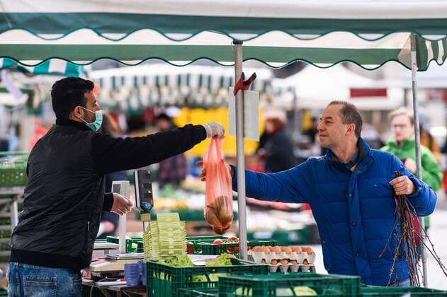 (200405) -- LEIPZIG, April 5, 2020 -- A vendor wearing a face mask sells farm products at a market in Leipzig, eastern Germany, April 4, 2020. More than 89,300 COVID-19 cases and at least 1,250 deaths have been registered as of Saturday afternoon across Germany, according to evaluations of the German Press Agency (DPA) which took into account the latest figures from all federal states. (Photo by Xinhua) GERMANY-LEIPZIG-COVID-19-CASES KevinxVoigt 