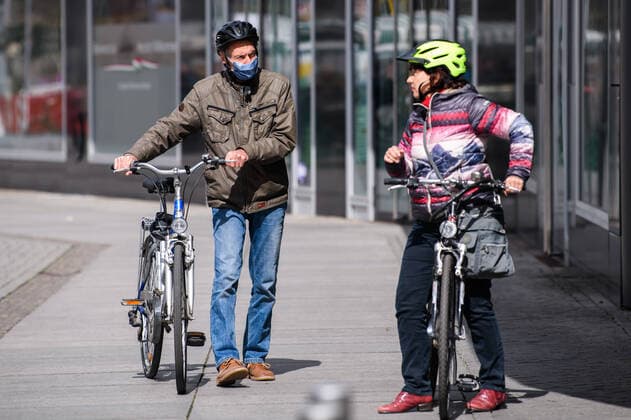 (200405) -- LEIPZIG, April 5, 2020 -- Two cyclists talk on a road in Leipzig, eastern Germany, April 4, 2020. More than 89,300 COVID-19 cases and at least 1,250 deaths have been registered as of Saturday afternoon across Germany, according to evaluations of the German Press Agency (DPA) which took into account the latest figures from all federal states. (Photo by Xinhua) GERMANY-LEIPZIG-COVID-19-CASES KevinxVoigt 