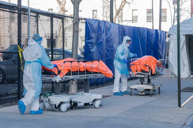 Coronavirus pandemic in NYC as seen on April 4 Body of deceased patient in orange bag moved from hospital to refrigerator truck serving as temporary morgue outside of Wyckoff Heights Medical Center in Brooklyn New York New York United States Copyright: LevxRadin