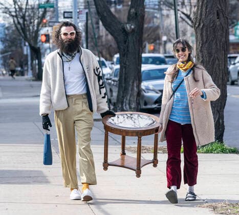 Coronavirus pandemic in NYC as seen on April 4 Happy couple with antique coffee table walk next to Wyckoff Heights Medical Center in Brooklyn New York New York United States Copyright: LevxRadin