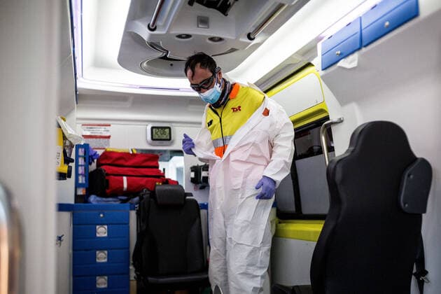 April 4, 2020, Girona, Spain: A worker from the emergency health service, undresses to throw away personal protective clothing after completing services..The emergency health services are forced to comply with specific protocols during the transfers of patients with possible cases of covid-19. At the end of the service they disinfect and throw the personal protective equipment in G-II bags to avoid contagions. Girona Spain - ZUMAs197 20200404_zaa_s197_150 Copyright: xMartixNavarrox