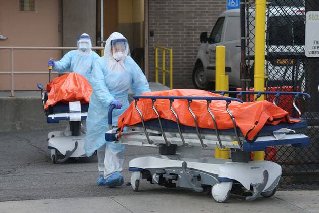April 4, 2020, New York City, NY, United States: A procession of the dead emerges from the backdoor of Wyckoff Heights Medical Center. Hospital workers push the gurneys carrying the recently deceased to a temporary morgue inside refrigerated container trucks. Their lives were all claimed by COVID-19 or the novel Coronavirus. New York City United States - ZUMAh16_ 20200404_zaf_h16_022 Copyright: xDanxHerrickx