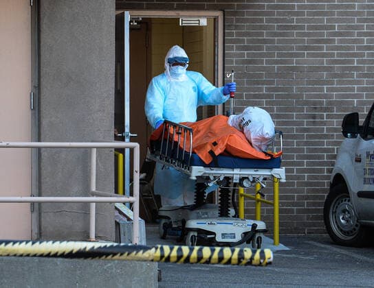 April 4, 2020, New Yok Brooklyn: Medical worker in protective clothing move a body to a refrigerated overflow morgue outside the Wyckoff Heights Medical Center in Brooklyn. 04 04 20 New York Brooklyn. New Yok Brooklyn - ZUMAs252 20200404_znp_s252_013 Copyright: xMarcusxSantosx