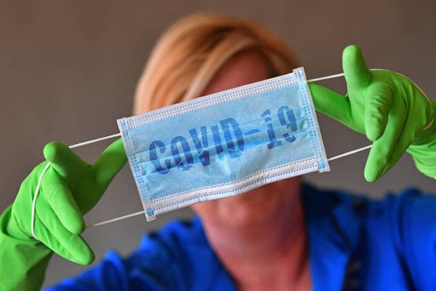 PHOTO MONTAGE Theme picture Coronavirus pandemic Protective mask and gloves A person holds a simple face protection,mask,simple protective mask with green protective gloves,
