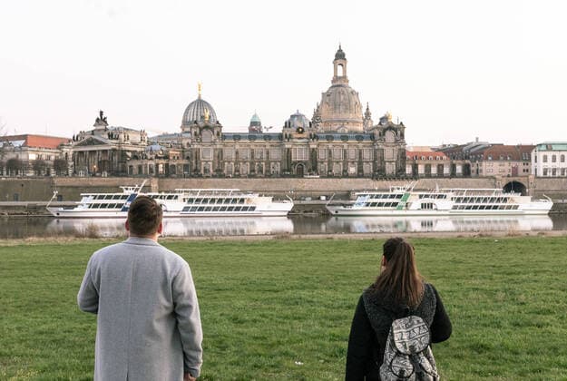 GER Sachsen Dresden Corona Pandemic two visitors of the Elbe river bank look at the skyline with Frauenkirche and ships of the Saechsische Dampfschifffahrts Gesellschaft 040420 ddbd