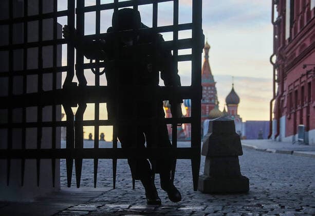 MOSCOW, RUSSIA - APRIL 5, 2020: A security guards opens the Iberian Gate to Red Square deserted due to a home isolation order declared for Moscow residents of all ages to restrict movement within the city and reduce the risk of contagion; a period off work with full pay has been extended until April 30 nationwide as part of preventive measures to contain the spread of the COVID-19 infection. Valery Sharifulin TASS  TS0D4749