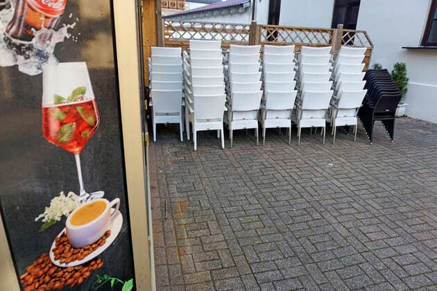 05 04 2020, Shops and restaurants close due to corona virus pandemic in Bad Wörishofen, Empty chairs stacked up at a closed ice cream parlour 05 04 2020, Closed restaurants due to corona virus 05 04 2020, Closed restaurants due to corona virus