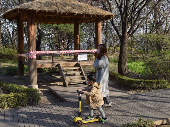 SEOUL, SOUTH KOREA - APRIL 5, 2020: A woman and a boy in face masks take a walk at Namsan Park; the South Korean authorities have called on citizens to stay home and observe social distancing, a self-isolation order to last until April 19. Stanislav Varivoda TASS  TS0D4786