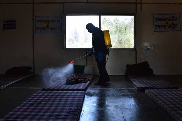 NEW DELHI, INDIA - APRIL 2: Workers from an NGO spray disinfectant during the sanitization of a night shelter on day 9 of the 21-day nationwide lockdown to check the spread of coronavirus, at Yamuna Pushta, Nigambodh Ghat, on April 2, 2020 in New Delhi, India. (Photo by Sanchit Khanna Hindustan Times) India Goes Into 21 Day Lockdown Due To Coronavirus COVID 19