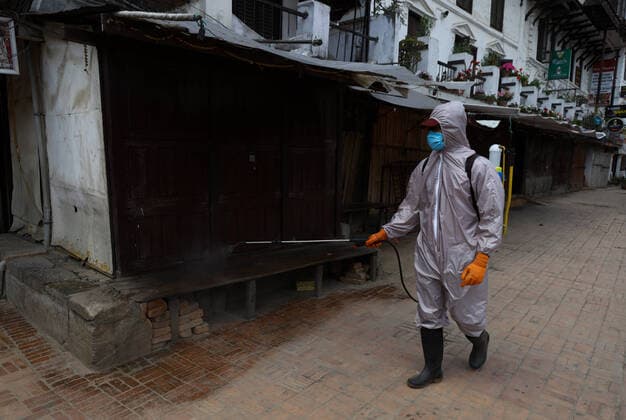 Lockdown in Nepal due to COVID-19 A Nepalese volunteer sprays disinfectants at Patan Durbar Square, a UNESCO World Heritage Site during the nationwide lockdown in Lalitpur, Nepal on Sunday, April 05, 2020. The government of Nepal has decided to impose a nationwide lockdown to prevent the spread of Coronovirus (COVID-19) outbreak. Bagmati Nepal Copyright: SubashxShrestha