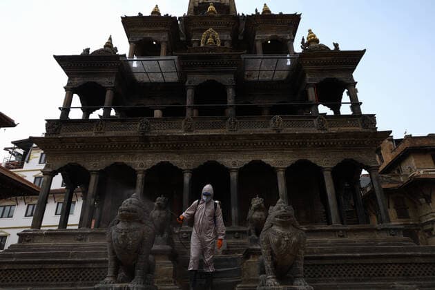 Lockdown in Nepal due to COVID-19 A Nepalese volunteer sprays disinfectants at Patan Durbar Square, a UNESCO World Heritage Site during the nationwide lockdown in Lalitpur. The government of Nepal has decided to impose a nationwide lockdown to prevent the spread of Coronovirus (COVID-19) outbreak. Bagmati Nepal Copyright: SubashxShrestha