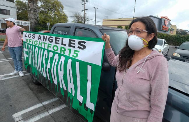 April 5, 2020, Los Angeles, California, U.S: Workers take part in a drive-thru strike at a McDonald s restaurant on Sunday, April 5, 2020 in Los Angeles. The workers are demanding a two-week quarantine period, with full pay for a co-worker who tested positive for COVID-19. Los Angeles U.S. - ZUMAc68_ 20200405_zaf_c68_010 Copyright: xRingoxChiux
