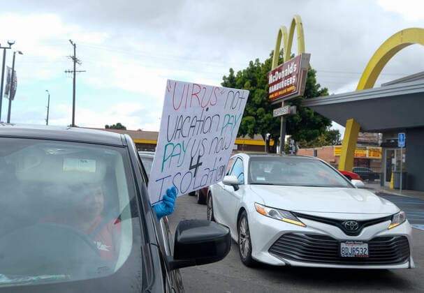 April 5, 2020, Los Angeles, California, U.S: A worker wearing gloves takes part in a drive-thru strike at a McDonald s restaurant on Sunday, April 5, 2020 in Los Angeles. The workers are demanding a two-week quarantine period, with full pay for a co-worker who tested positive for COVID-19. Los Angeles U.S. - ZUMAc68_ 20200405_zaf_c68_014 Copyright: xRingoxChiux