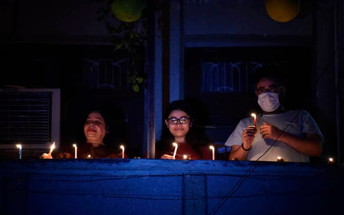 NEW DELHI, INDIA APRIL 5: People lighting lamps (diyas, candles and phone torch) at their homes to express their solidarity towards nation s fight against coronavirus, at Meena apartment, Patparganj, in East Delhi, on April 5, 2020 in New Delhi, India. Millions of Indians across the country switched off lights at their homes and lit candles and diyas or turned on mobile phone torches on Sunday night, responding to Prime Minister Narendra Modi s appeal to show the nation s collective resolve and solidarity in its fight against coronavirus with this symbolic gesture. (Photo by Ajay Aggarwal Hindustan Times ) Millions Of Indians Light Candles, Diyas, Turn On Mobile Phone Torches After Prime Minister Modi?s Appeal