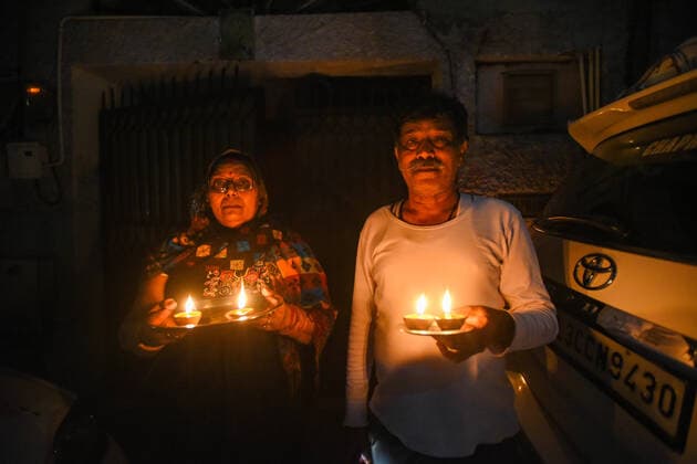 NEW DELHI, INDIA APRIL 5: People with earthen lamps (diyas) in a show of solidarity and support for frontline workers, on day twelve of the nationwide lockdown to combat coronavirus, at Green Park, on April 5, 2020 in New Delhi, India. Millions of Indians across the country switched off lights at their homes and lit candles and diyas or turned on mobile phone torches on Sunday night, responding to Prime Minister Narendra Modi s appeal to show the nation s collective resolve and solidarity in its fight against coronavirus with this symbolic gesture. (Photo by Amal KS Hindustan Times ) Millions Of Indians Light Candles, Diyas, Turn On Mobile Phone Torches After Prime Minister Modi?s Appeal