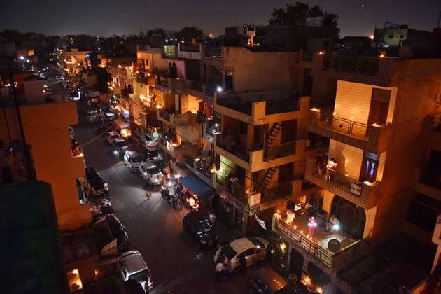 NEW DELHI, INDIA APRIL 5: People s homes lit up with candles and earthen lamps (diyas) in a show of solidarity and support for frontline workers, on day twelve of the nationwide lockdown to combat coronavirus, at Moti Nagar, on April 5, 2020 in New Delhi, India. Millions of Indians across the country switched off lights at their homes and lit candles and diyas or turned on mobile phone torches on Sunday night, responding to Prime Minister Narendra Modi s appeal to show the nation s collective resolve and solidarity in its fight against coronavirus with this symbolic gesture. (Photo by Sanchit Khanna Hindustan Times ) Millions Of Indians Light Candles, Diyas, Turn On Mobile Phone Torches After Prime Minister Modi?s Appeal