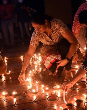 (200405) -- NEW DELHI, April 5, 2020 (Xinhua) -- An Indian woman lights a candle to mark the country s fight against COVID-19 pandemic in Kochi, India, on April 5, 2020. India s health ministry Sunday evening said the death toll due to COVID-19 in India rose to 83 and the total number of confirmed cases in the country reached 3,577. (Str Xinhua) INDIA-KOCHI-COVID-19-CASES 