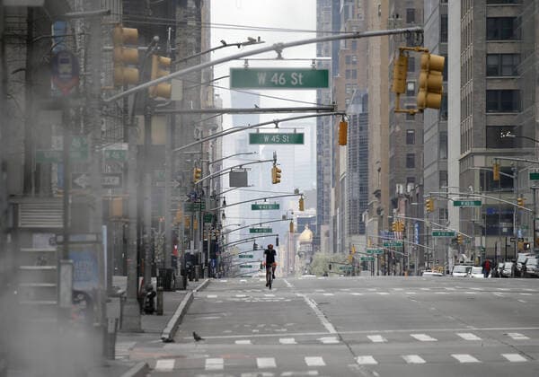 A cyclist rides on an almost empty of pedestrian and automobile traffic 5th Avenue on Palm Sunday In New York City on Sunday, April 5, 2020. Cardinal Timothy Dolan today held a virtual Palm Sunday mass from St. Patrick s Cathedral. Coronavirus cases in the U.S. rose to over 300,000 and the number of deaths rose to more than 8,000 Globally the death toll has been reported at more than 65,000.  NYP20200405120 JOHNxANGELILLO
