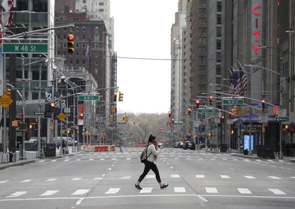 Sixth Avenue near Radio City Music Hall is almost completely empty of pedestrian and automobile traffic on Palm Sunday In New York City on Sunday, April 5, 2020. Cardinal Timothy Dolan today held a virtual Palm Sunday mass from St. Patrick s Cathedral. Coronavirus cases in the U.S. rose to over 300,000 and the number of deaths rose to more than 8,000 Globally the death toll has been reported at more than 65,000.  NYP20200405118 JOHNxANGELILLO