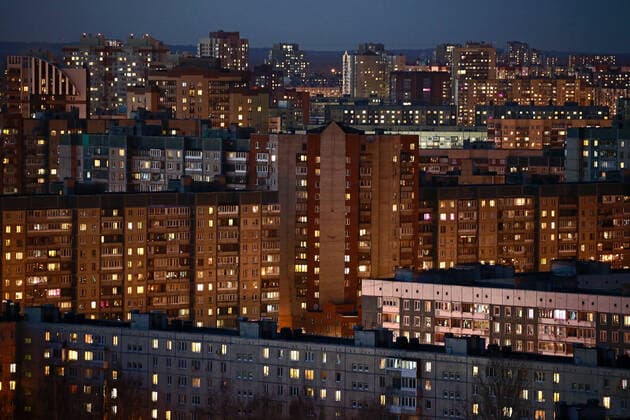 ST PETERSBURG, RUSSIA - APRIL 5, 2020: Lit windows in apartment blocks in Nevsky District. A home isolation order was declared for St Petersburg residents of all ages to restrict movement within the city and reduce the risk of coronavirus contagion, effective since March 30, 2020; a period off work with full pay was extended until April 30 nationwide as part of preventive measures to contain the spread of the COVID-19 infection. Peter Kovalev TASS  TS0D4804