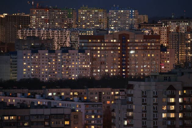 ST PETERSBURG, RUSSIA - APRIL 5, 2020: Lit windows in apartment blocks in Nevsky District. A home isolation order was declared for St Petersburg residents of all ages to restrict movement within the city and reduce the risk of coronavirus contagion, effective since March 30, 2020; a period off work with full pay was extended until April 30 nationwide as part of preventive measures to contain the spread of the COVID-19 infection. Peter Kovalev TASS  TS0D4805